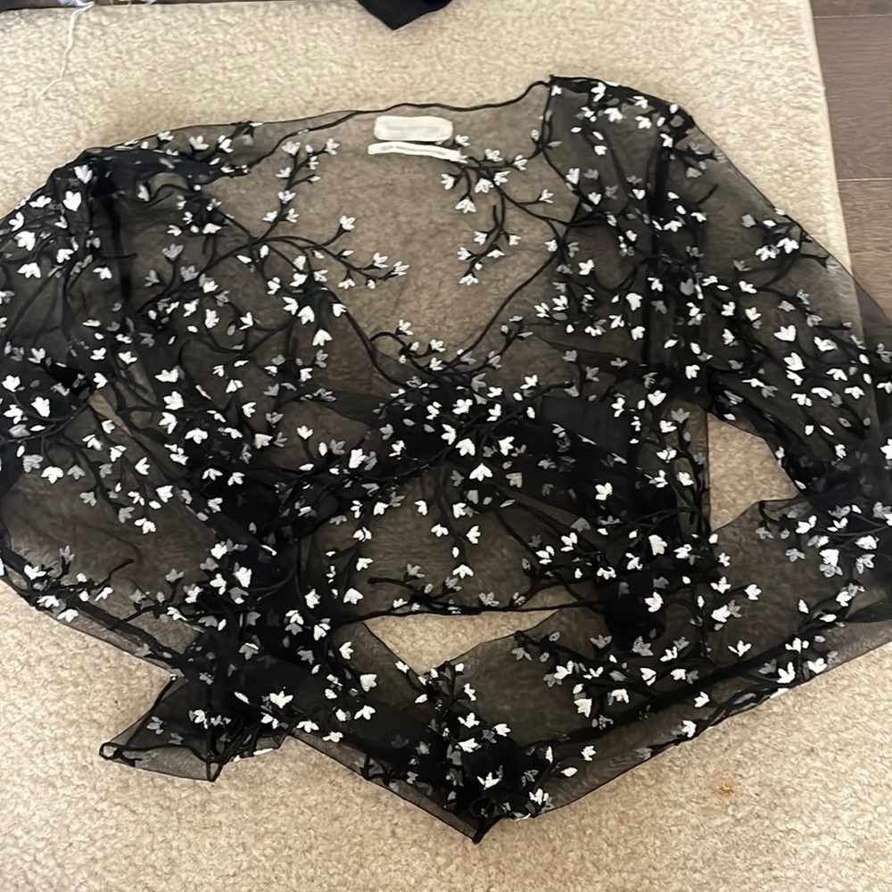 Super adorable little see through tie top from urban with white flower embellish